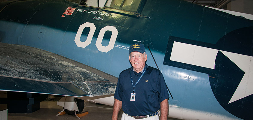 RADM James Flatley poses with one of his father's planes from WWII. &copy; 2016 Audra L. Gibson. All Rights Reserved.