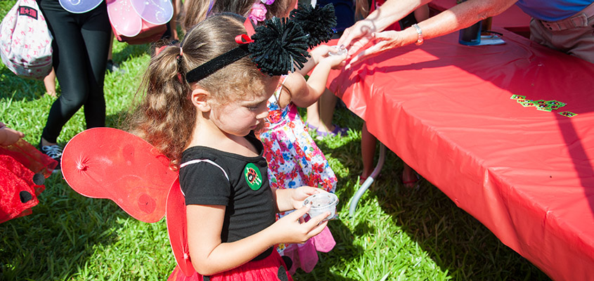 Volunteers distribute ladybugs to children to release into the gardens. &copy; 2016 Audra L. Gibson