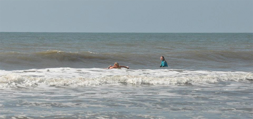 Leah paddles for a wave. Folly Beach, SC. &copy; 2012 Hannah Lane Photography. All Rights Reserved.